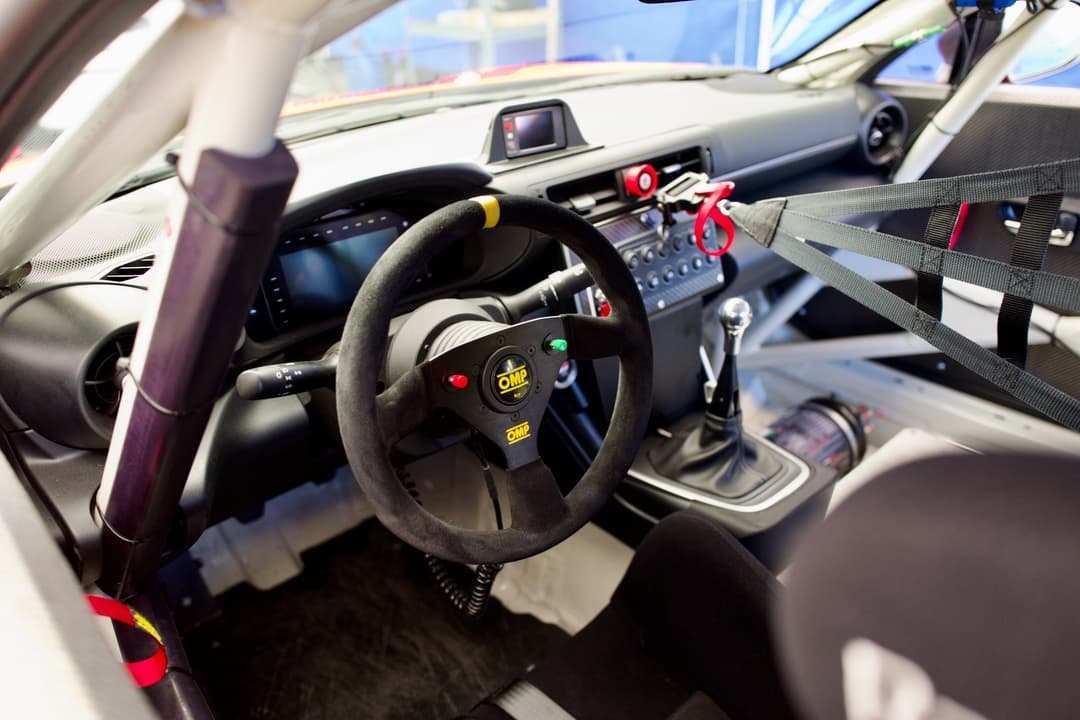 Looking into the interior of a GR Cup car through the driver's side window