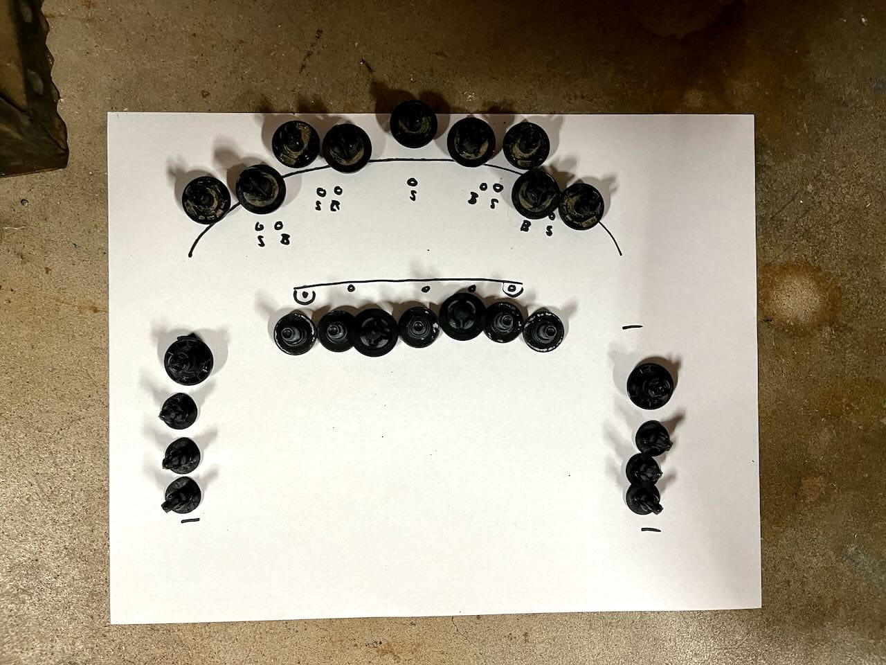 Fasteners laid out on a piece of paper with drawings of where each one will be reinstalled. As long as it makes sense to you, that’s good enough. I believe in this case, I actually removed more pop clips than necessary on the front lip.